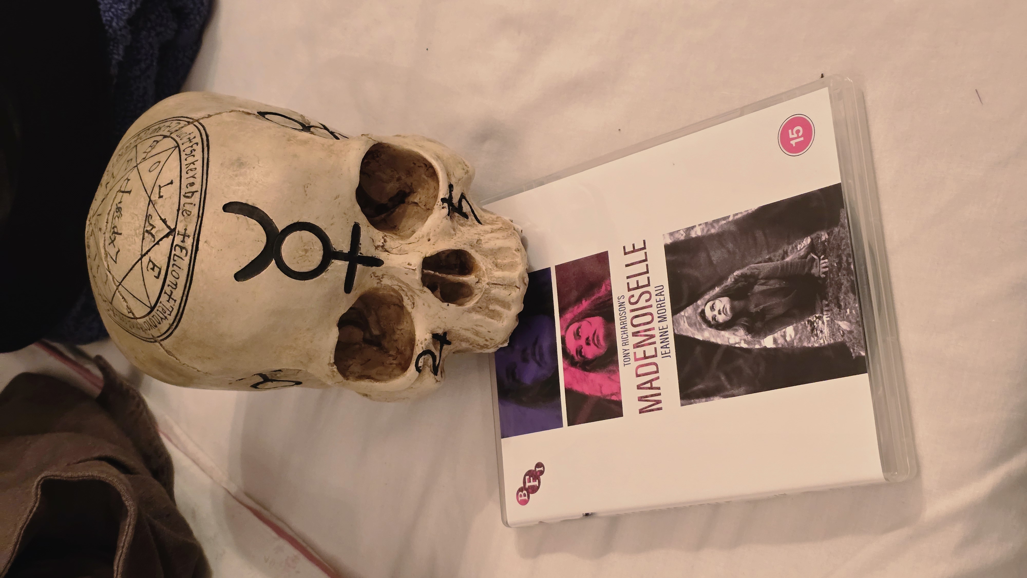A sigil-marked skull beside the BFI edition of Mademoiselle