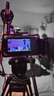 Monitor view of a bedroom scene during filming