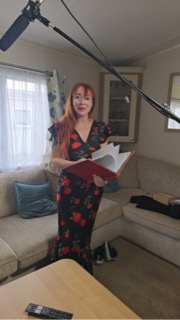Eileen Daly reading from the red book under the boom microphone
