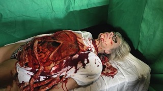 Heather Waugh in full prosthetic gore make-up on set