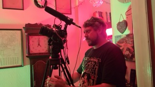 Jason Impey behind the camera under red light