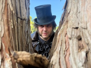 The Ripper watching from between two trees