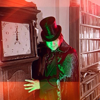 The Ripper beside the grandfather clock, lit red and green