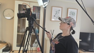Rachel Impey operating the boom beside the camera